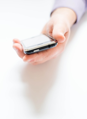Man holding and uses a mobile phoneの写真素材