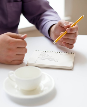 Businessman using a tablet pc and write somethingの写真素材