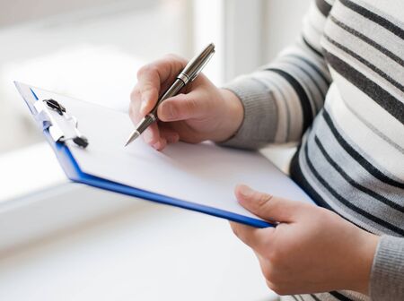 Businessman writing on the document tableの写真素材