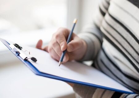 Businessman writing on the document tableの写真素材