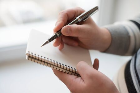 Businessman writing on the document table