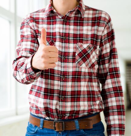 engineer in a helmet holding thumb upの写真素材