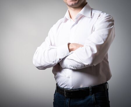 Successful businessmen with folded arms on a gray backgroundの写真素材