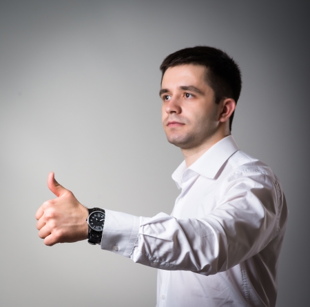 Successful cheering business man holding his thumb upの写真素材
