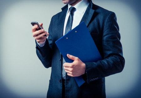 man with a clipboard talking on the phoneの写真素材
