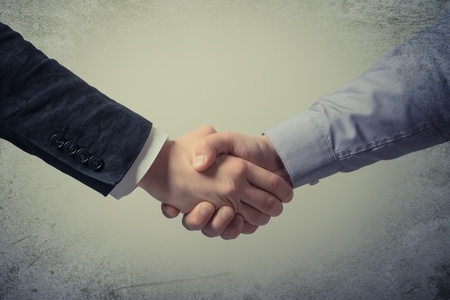 Handshake - Hand holding on gray backgroundの写真素材