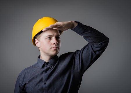engineer in helmet looks into the distanceの写真素材