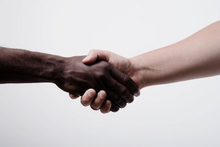 African American businessman shaking hands with caucasian businessmanの写真素材