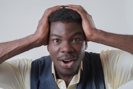 African-American holds his hands behind his headの写真素材