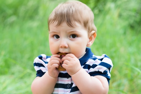 little boy eats a bagel