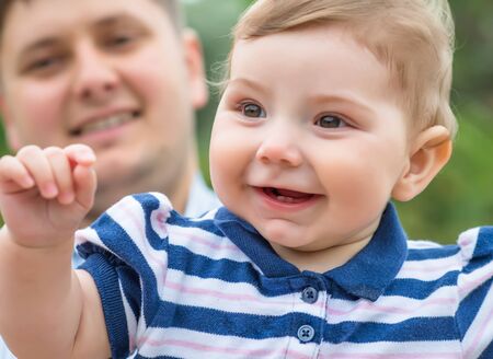 young father holding his son in his armsの写真素材
