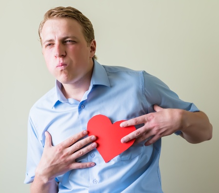 young man holding a heartの写真素材