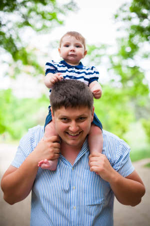 young father holding his young sonの写真素材