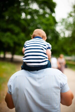 young father holding his young sonの写真素材