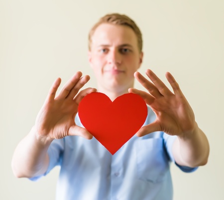 young man holding a heartの写真素材