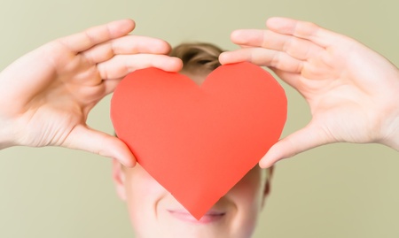 young man holding a heartの写真素材