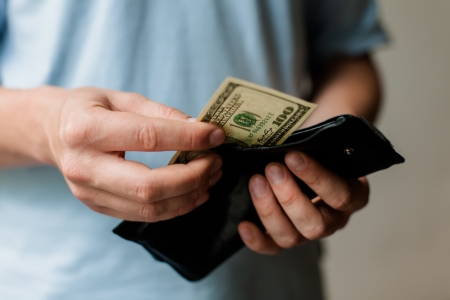 Man gets money from the walletの写真素材