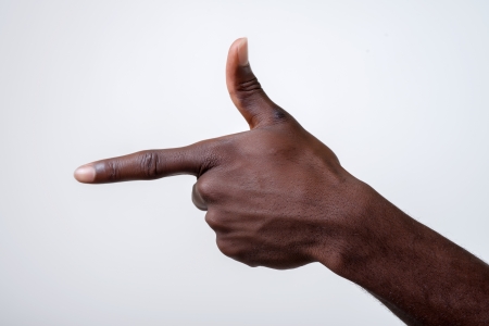 African-American young man points his index fingerの写真素材