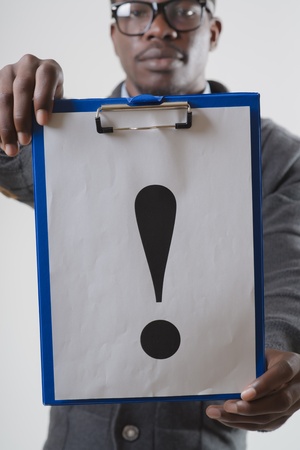 African-American man holding a exclamation markの写真素材