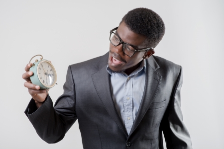 African-American businessman holding an alarm clockの写真素材