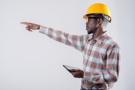 African-American man in a helmet with a digital tabletの写真素材
