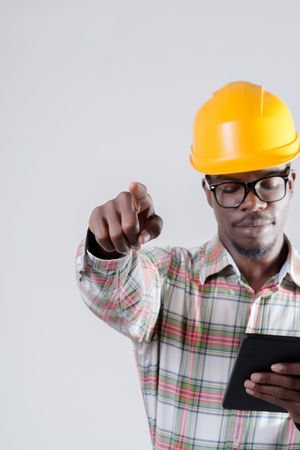 African-American man in a helmet with a digital tabletの写真素材