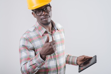 African-American man in a helmet with a digital tabletの写真素材