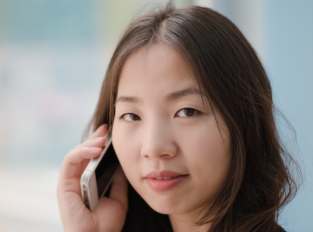 beautiful young woman talking on a smartphoneの写真素材