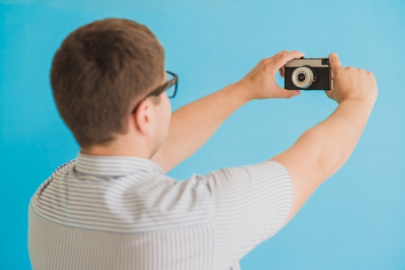 young man photographed on a retro cameraの写真素材