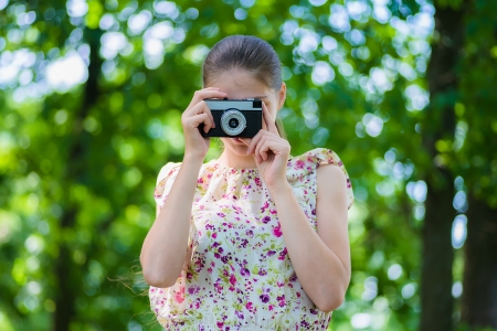 beautiful young woman with a cameraの写真素材