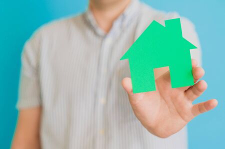 young man  holding a houseの写真素材
