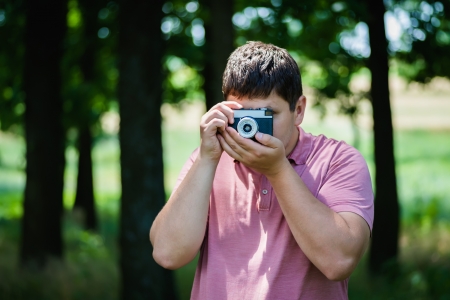 young man photographed on a retro cameraの写真素材