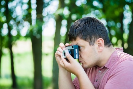 young man photographed on a retro cameraの写真素材