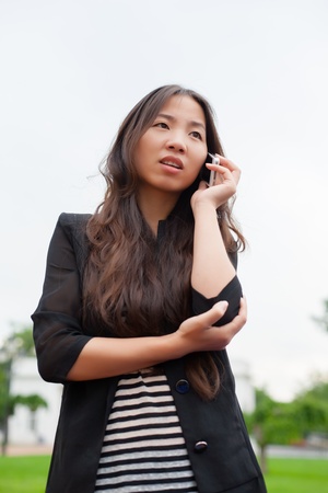 beautiful young woman talking on a smartphoneの写真素材