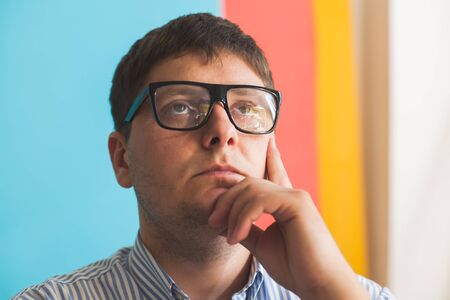 thoughtful man with glassesの写真素材