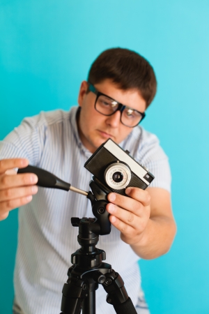 young man photographed on a retro cameraの写真素材