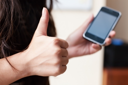 beautiful young woman uses a smartphoneの写真素材