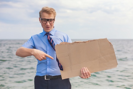 young man holds a placard, posterの写真素材