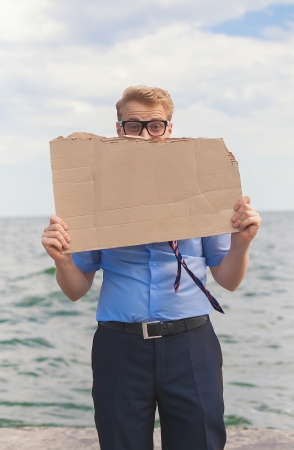 young man holds a placard, posterの写真素材