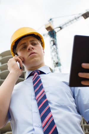 engineer in a helmet with a digital tabletの写真素材