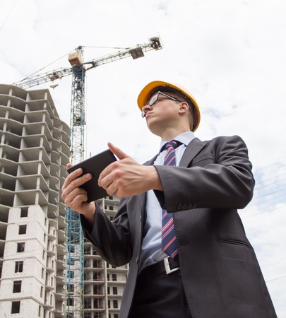 engineer in a helmet with a digital tabletの写真素材