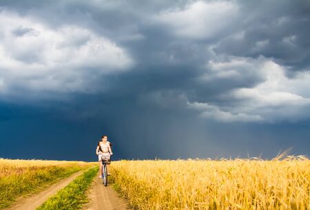 young woman with bicycle in the natureの写真素材