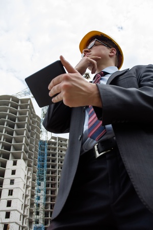 engineer in a helmet with a digital tabletの写真素材
