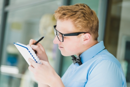 man in glasses with a note-bookの写真素材