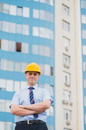 Young successful engineer in a helmet