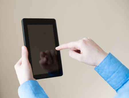 woman uses a digital tablet. Modern gadget in hand.