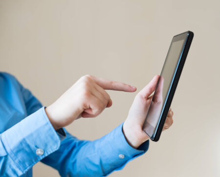 woman uses a digital tablet. Modern gadget in hand.