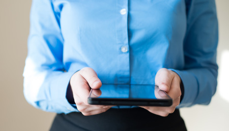 woman uses a digital tablet. Modern gadget in hand.の写真素材