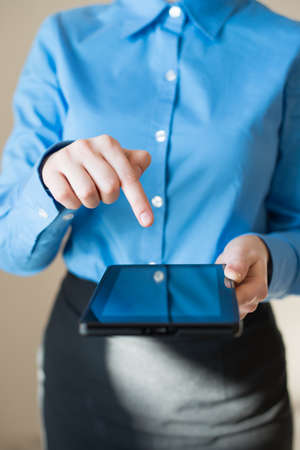 woman uses a digital tablet. Modern gadget in hand.の写真素材