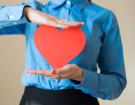 woman holds a heart in his handsの写真素材